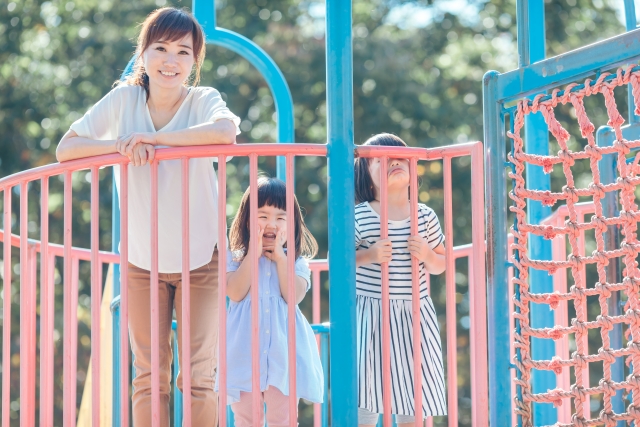 遊具の上で笑顔の親子